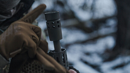 Soldier on a military recon mission in the wilderness. Frozen forest at winter. Examining the state...