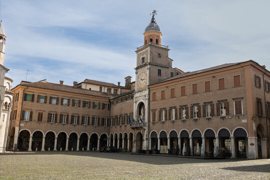 Municipal Palace of Modena with archways in Grande Square, Italy