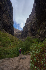 Fototapeta premium Hiker in dramatic narrow canyon