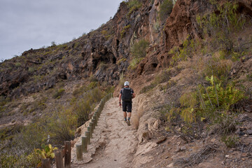 Hiker ascending canyon trail Tenerife © Xalanx