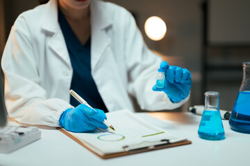 Scientist hands holding vial doing chemistry research
