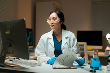 Female scientist researching data and conducting experiments in laboratory
