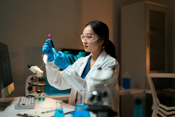 Female scientist analyzing blood sample in laboratory