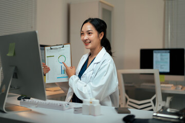 Asian doctor woman teleconsulting pointing at medical chart data