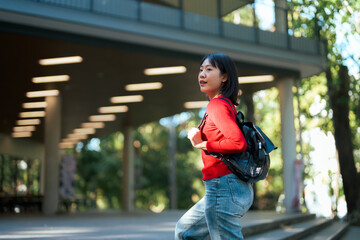 Asian student woman walking on university campus