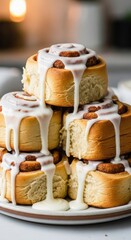 Naklejka premium A stack of cinnamon rolls with white icing drizzled on top sitting on a white plate dessert