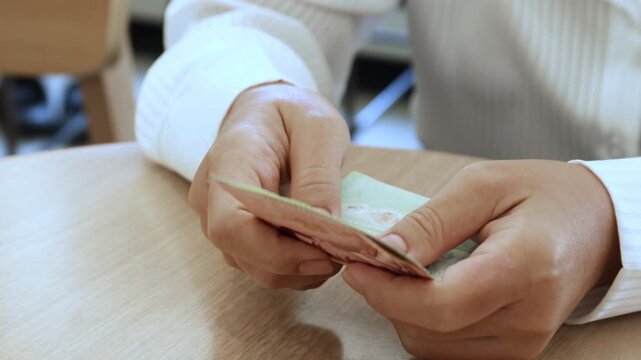 Hands counting Thai banknotes, Money, Cash, management, income, expenses, and financial transactions