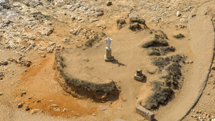 Aerial view of the southernmost point of Italy, where a statue of the Redeemer has been placed. This location is near Portopalo, in the province of Syracuse, Sicily, Italy. It's a sunny summer day.