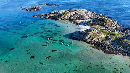 Obraz premium Drone photo of paddleboarders on the Norwegian coast