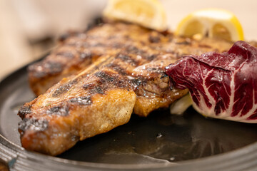 Juicy beef steak on elegant plate in restaurant fine dining setting close up view