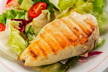 Grilled chicken breast salad chicken breast tomato, green leaf lettuce, salad mix snack vegetablestasty snack fresh gourmet food background on the table rustic top view copy space keto and paleo diet