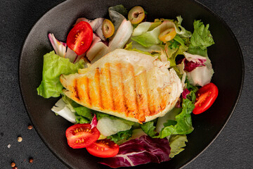 Grilled chicken breast salad chicken breast tomato, green leaf lettuce, salad mix snack vegetablestasty snack fresh gourmet food background on the table rustic top view copy space keto and paleo diet