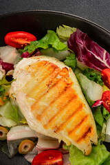 Grilled chicken breast salad chicken breast tomato, green leaf lettuce, salad mix snack vegetablestasty snack fresh gourmet food background on the table rustic top view copy space keto and paleo diet