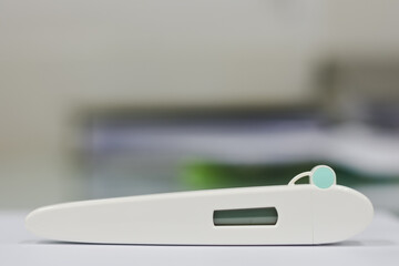 Digital thermometer test kit with display on white surface