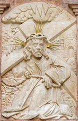 Selbstklebende Fototapeten Jesus Christus SALZBURG, AUSTIRA - SEPTEMBER 8 2025: The stone relief of Jesus with the cross on exterior wall of the chapel Margarethenkapelle in the St. Peter Abtei cemetery by unknown artist.   © Renáta Sedmáková