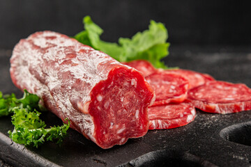 Dry sausage slice pork less fat jamon cured meat natural product tasty snack fresh delicious gourmet food background on the table rustic top view copy space