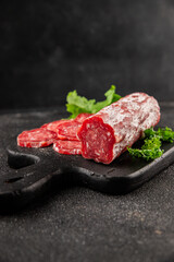 Dry sausage slice pork less fat jamon cured meat natural product tasty snack fresh delicious gourmet food background on the table rustic top view copy space