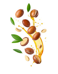 Argun Nuts and Oil with Green Leaves - Transparent Background - Cracked open nuts Falling - Food Image for Health and Beauty - Raw Food and Cosmetic Ingredient - Hair Shampoo and Vitamin Benefits