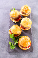 buffet table with mini burger, serving food, catering banquet table