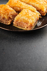 Baklava with pistachios and almonds dessert oriental sweets natural product tasty snack fresh delicious gourmet food background on the table rustic top view copy space