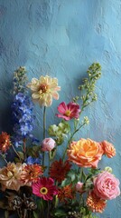 Fototapeta premium Colorful Floral Arrangement Showcasing Various Blooms Against a Textured Blue Background