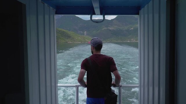 Man overwatching river canyon of Koman reservoir in Albania from a ship
