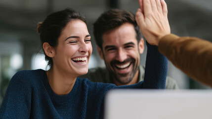Fototapeta premium Joyful collaboration among friends in a modern workspace setting