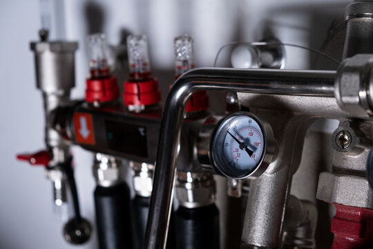 Complex residential heating manifold system with valves, gauges, and piping network