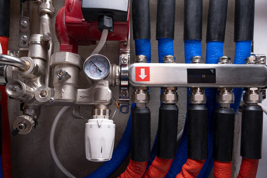 Complex residential heating manifold system with valves, gauges, and piping network