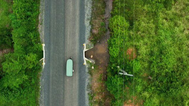 Traditional Asian Tuk Tuk is riding through the forest