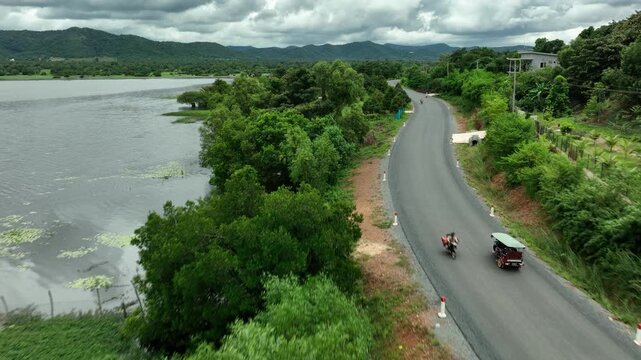Traditional Asian Tuk Tuk is riding through the forest