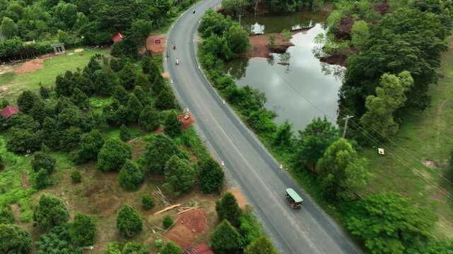 Traditional Asian Tuk Tuk is riding through the forest