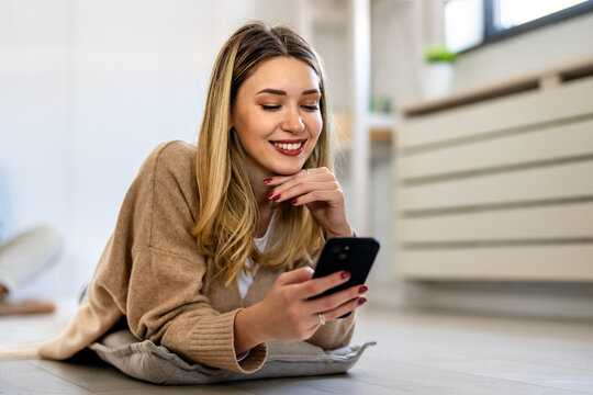 Happy woman using her smartphone for online shopping, digital administration, social media browsing - Powered by Adobe