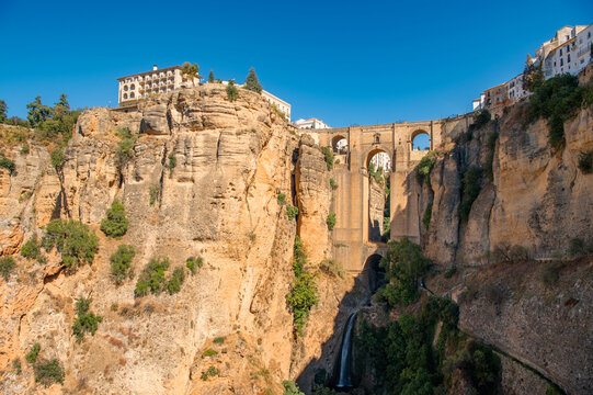 View of Puente Nuevo New Bridge and Tajo de Ronda gorge in Ronda at sunny day, Andalusia, Spain. Travel destination.
