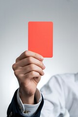 Referee shows red card to player in sporting event, discipline concept