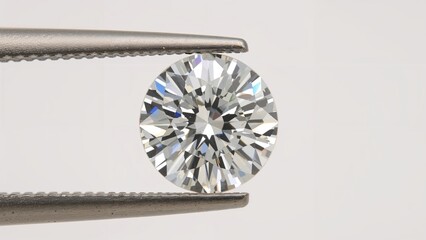 A diamond held with tweezers, showcasing a round brilliant cut.