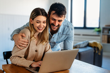 Man and woman working remotely using laptop. Male female freelancers working together. Digital nomad