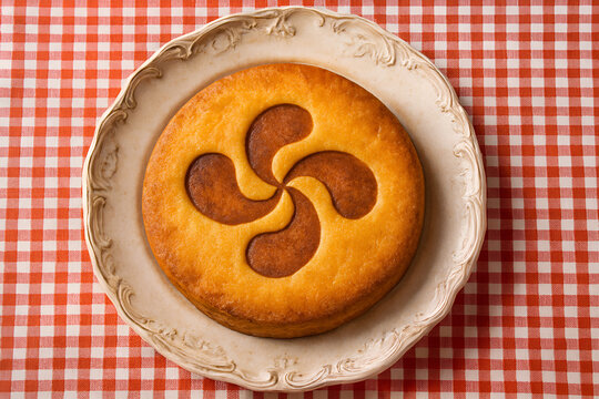 Traditional Basque Cake or Basque gateaux with Lauburu Symbol on Decorative Plate