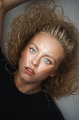 Close-Up Portrait of a Young Woman with Curly Hair and Bright Eyes
