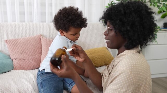 Handyman using an electric drill to install a kitchen cabinet door hinge