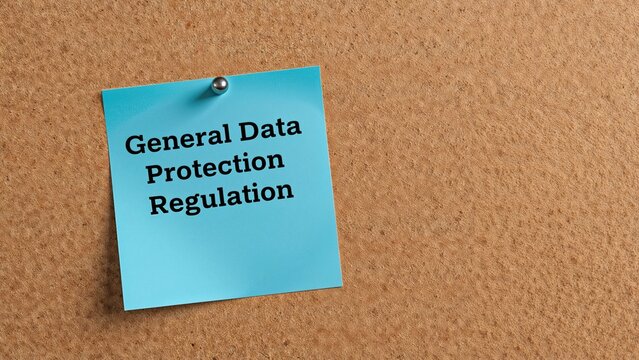 General Data Protection Regulation on a blue sticky note pinned to a corkboard.