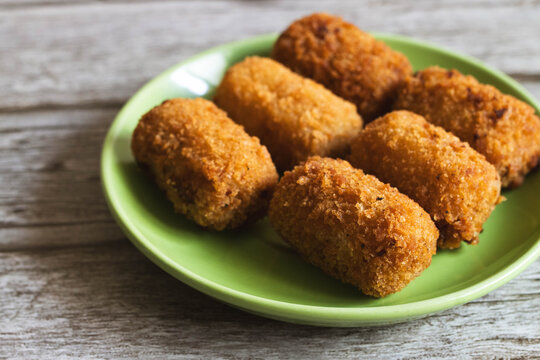Crispy Homemade Croquettes on a Green Plate