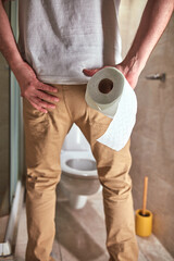 Man with urge to go to the toilet at home.
