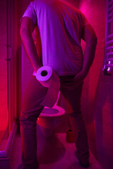 Man with urge to go to the toilet at home.