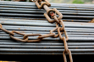 Heavy Steel Rods Secured with Chain for Construction Transport Safety