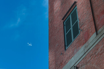 red brick building hong kong and jet airliner