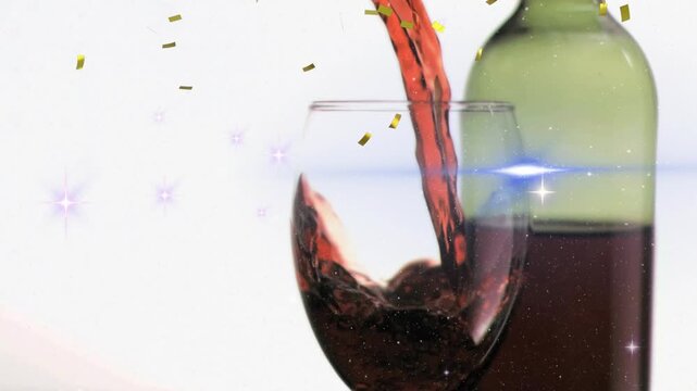 On bottle tipping, red wine pouring into clear stemmed glass, forming swirls to showcase product