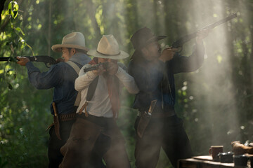 Group of cowboys aiming rifles in a forest camp, with sunlight streaming through the smoke
