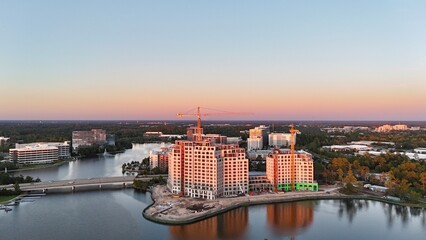 Ongoing construction of tall building by the lake at sunset in USA 