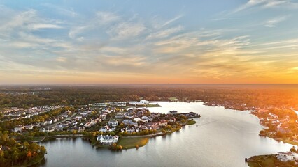 Aerial view of large mansion houses with swimming pool,  in affluent neighborhood  by Woodlands lake, Houston, Texas, expensive suburban homes surrounding by lush green trees at sunset, USA 